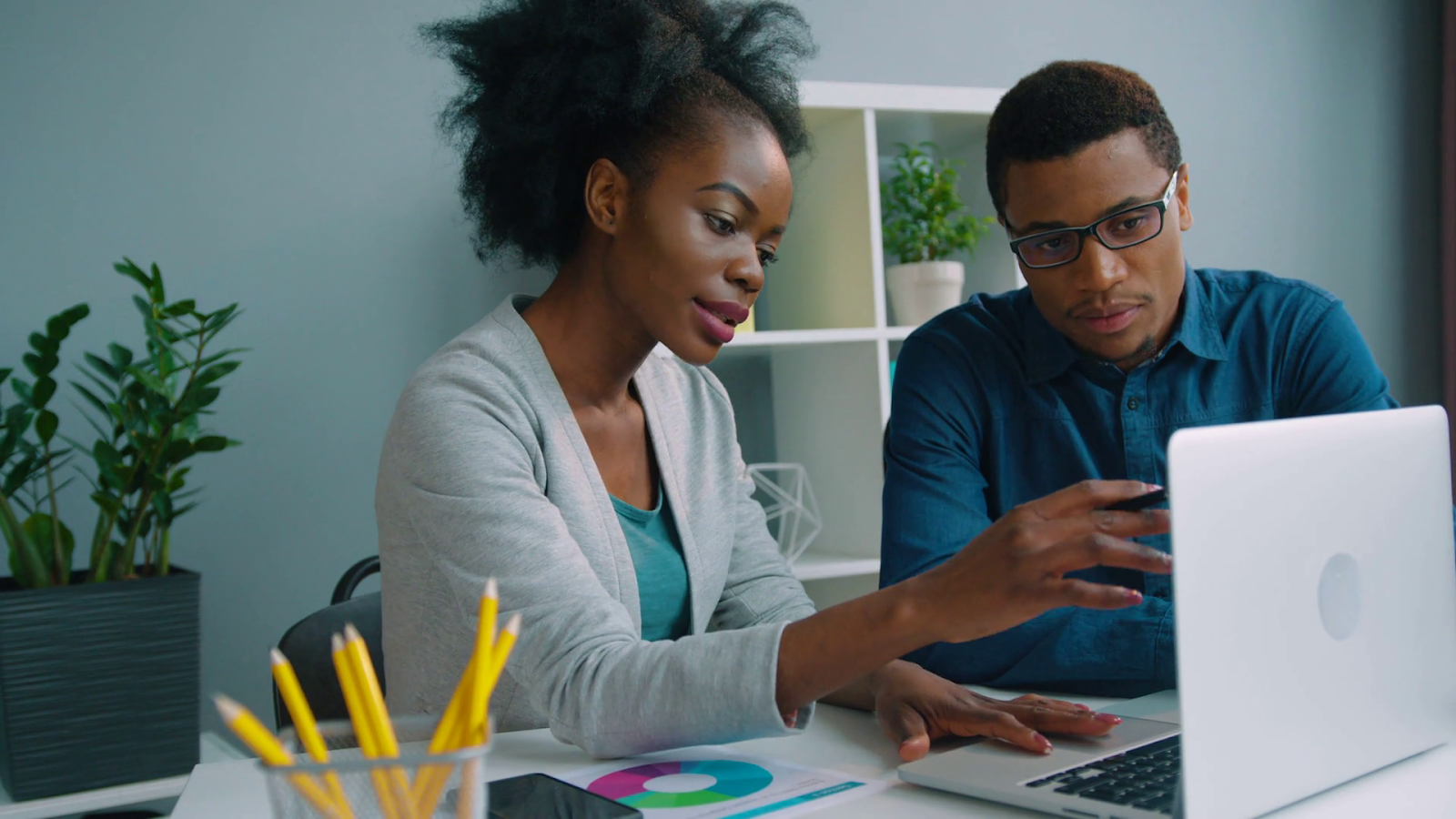 2 person looking at a laptop